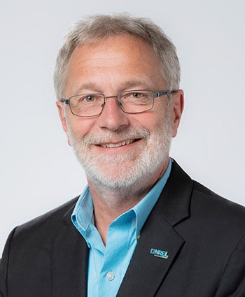 Martin Keller, a bearded white man with glasses wearing a black blazer and blue button down shirt
